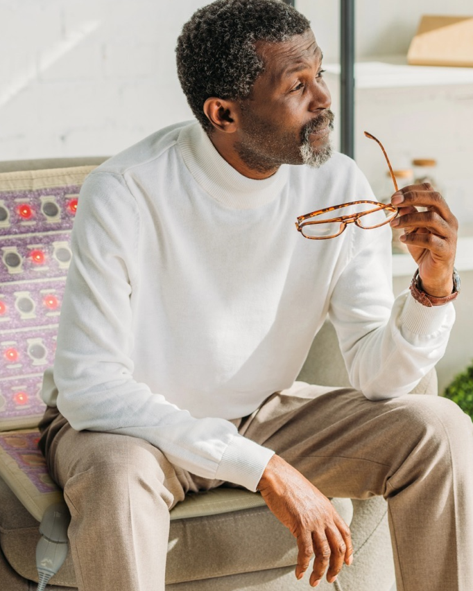 Man sitting on a chair using a HealthyLine chair PEMF mat for osteoarthritis treatment. Man sitting on a chair using a HealthyLine chair PEMF mat for osteoarthritis treatment.