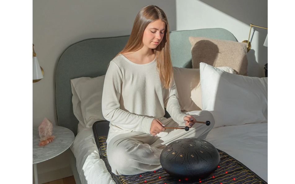 Woman playing singing bowls while seated on a HealthyLine Pro Jet