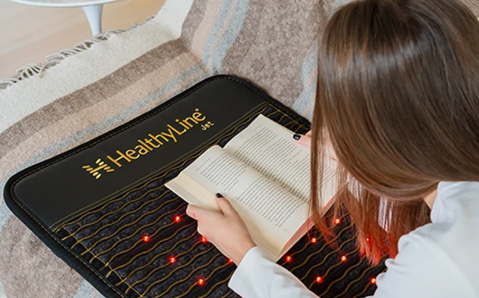 Woman relaxing and reading on a Healthyline Jet mat