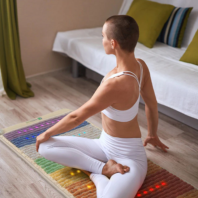 Woman performing yoga on a HealthyLine Rainbow Chakra Mat