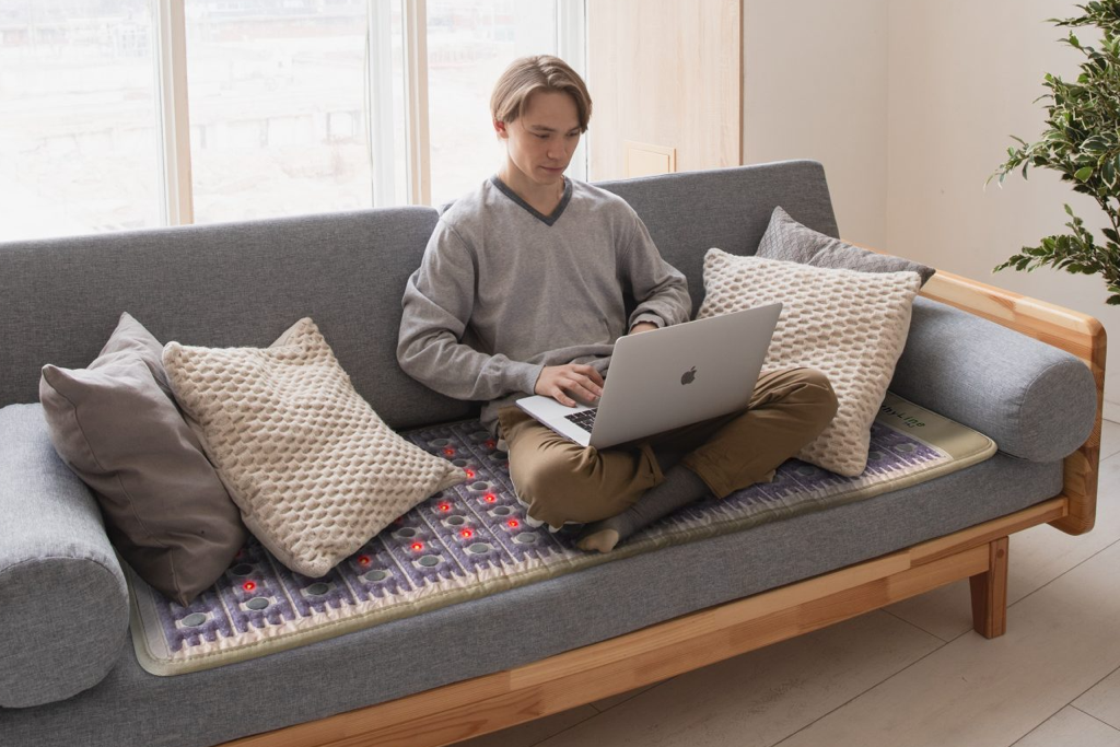 Young man sitting on a healthyline TAJ mat  7224