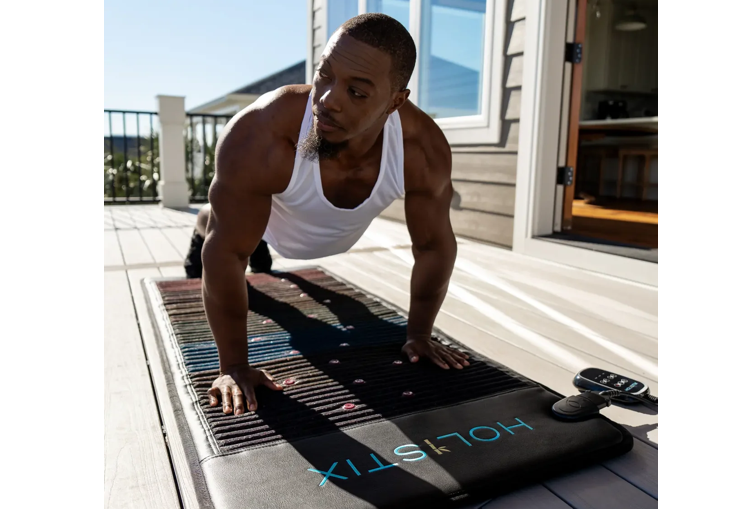 Man performing yoga on a Holistix PEMF mat Man performing yoga on a Holistix PEMF mat