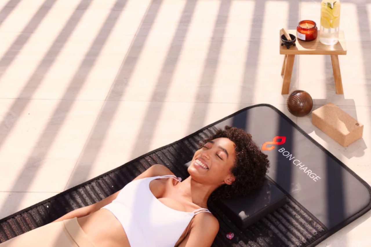 woman lying on a PEMF mat doing gentle stretching woman lying on a PEMF mat doing gentle stretching
