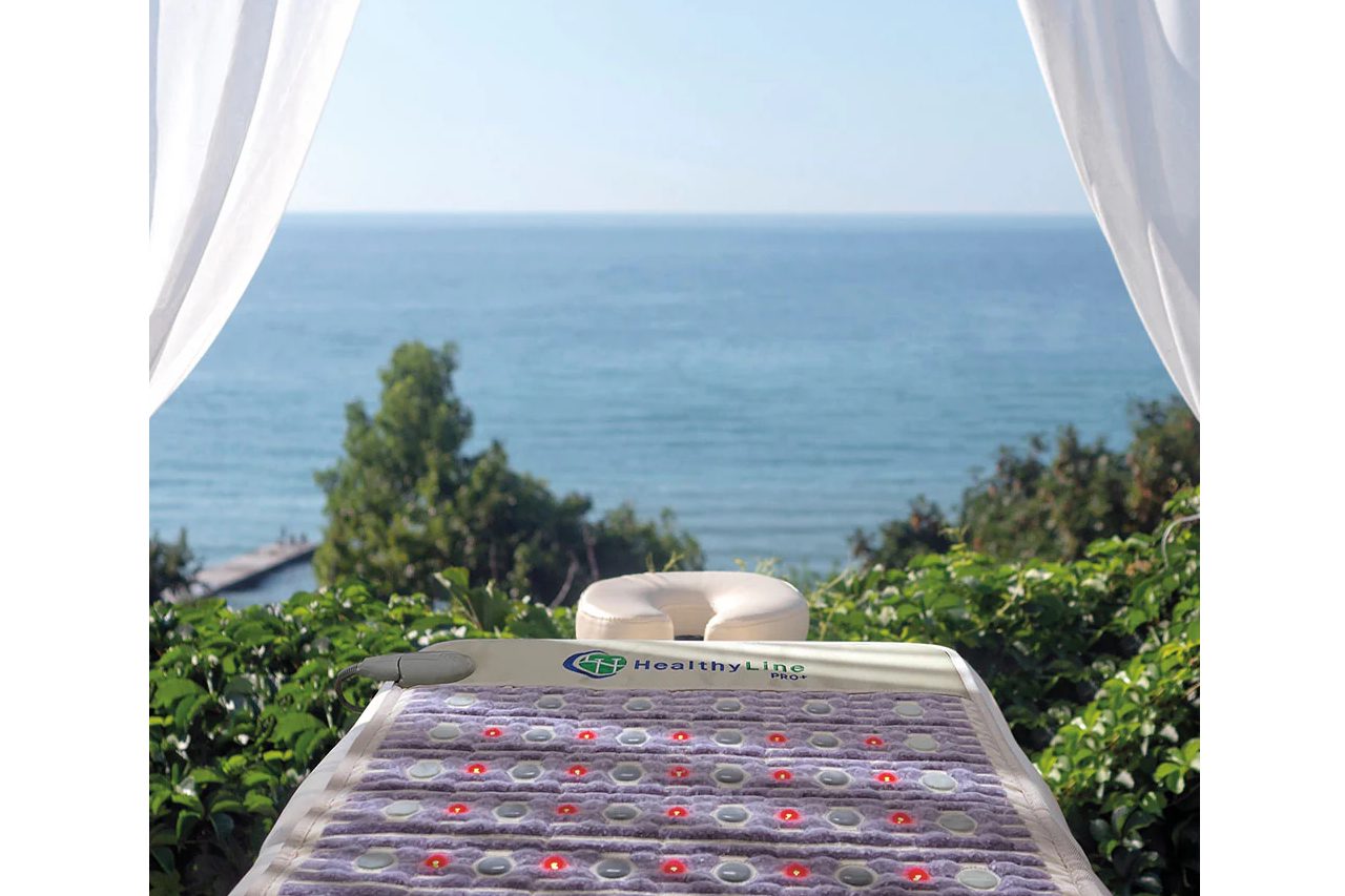 PEMF mat therapy setup in a spa center with sauna essential oils nearby
