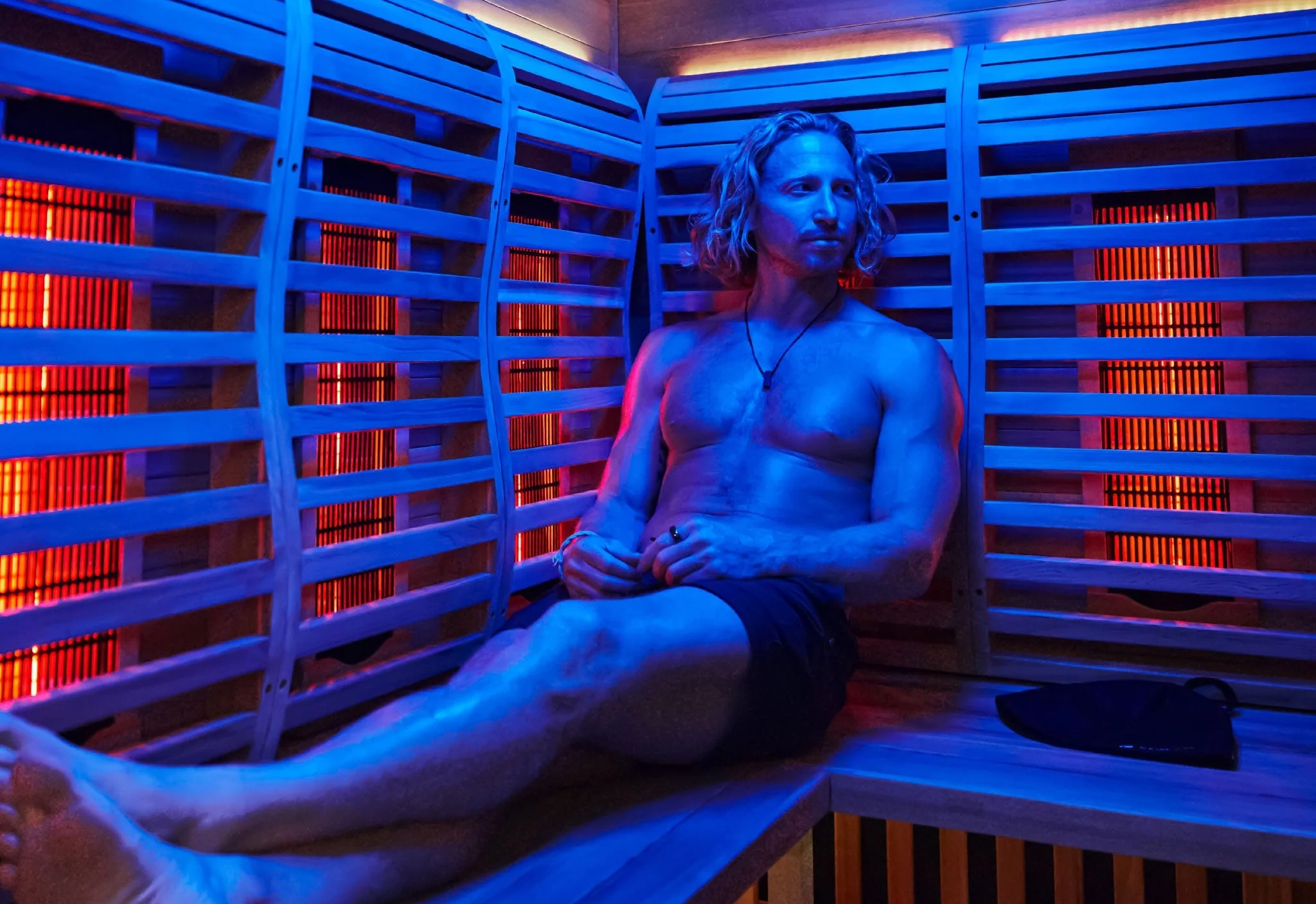 Man relaxing in a home sauna, practicing skin care during a sauna session