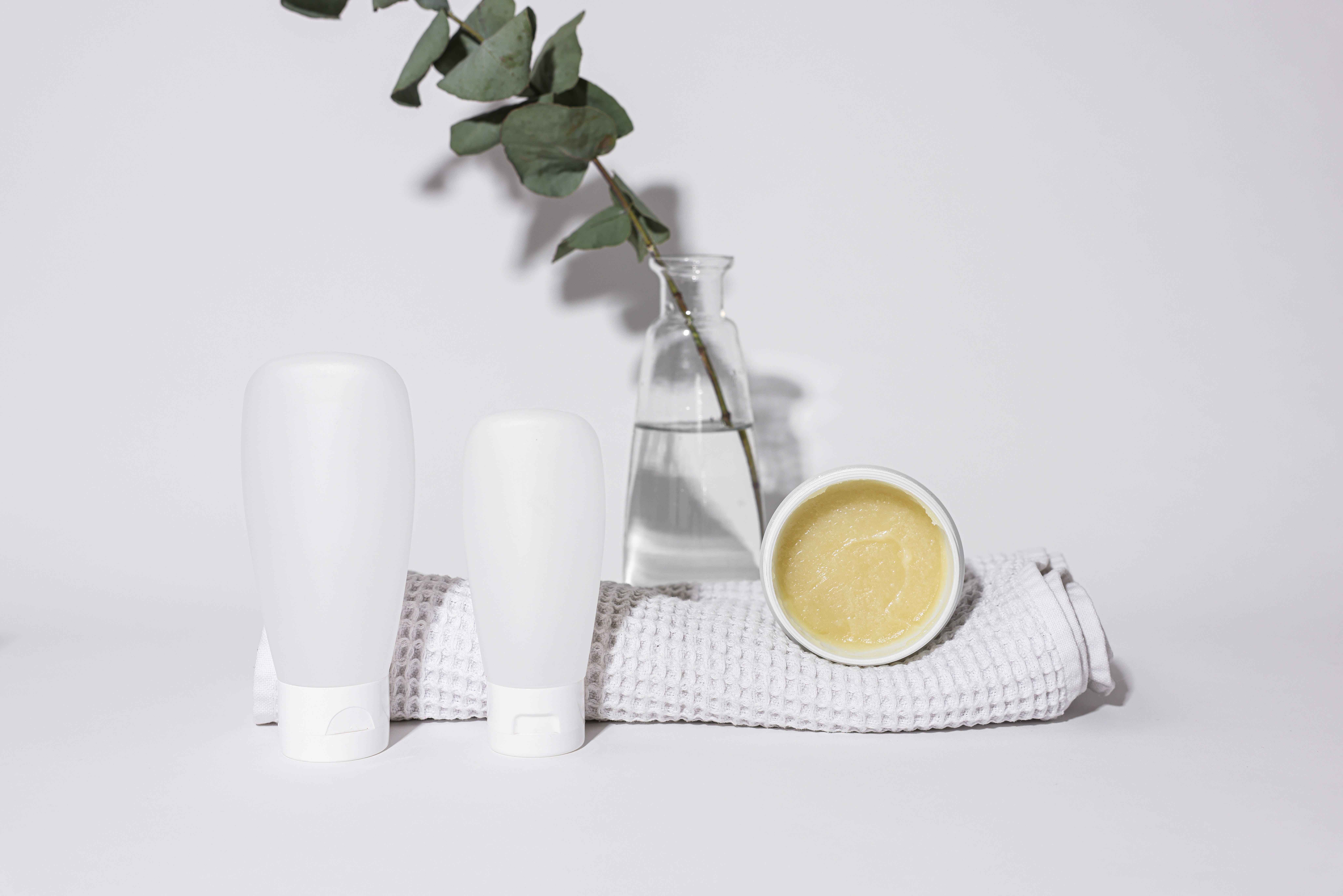 Towel neatly arranged with various skincare tools and products, supporting skin care and safety before and during sauna sessions.