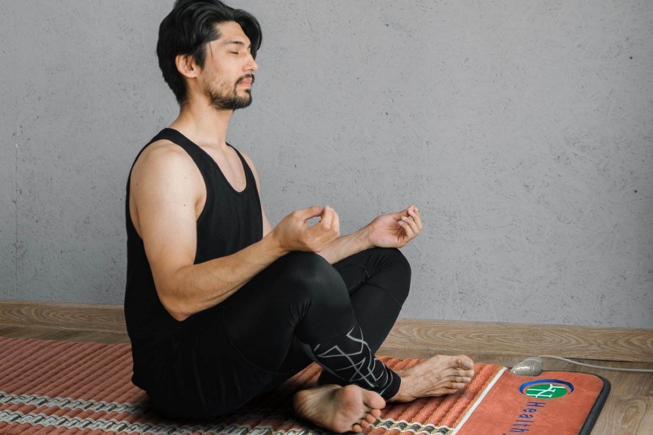Man meditating on a HealthyLine TAO mat