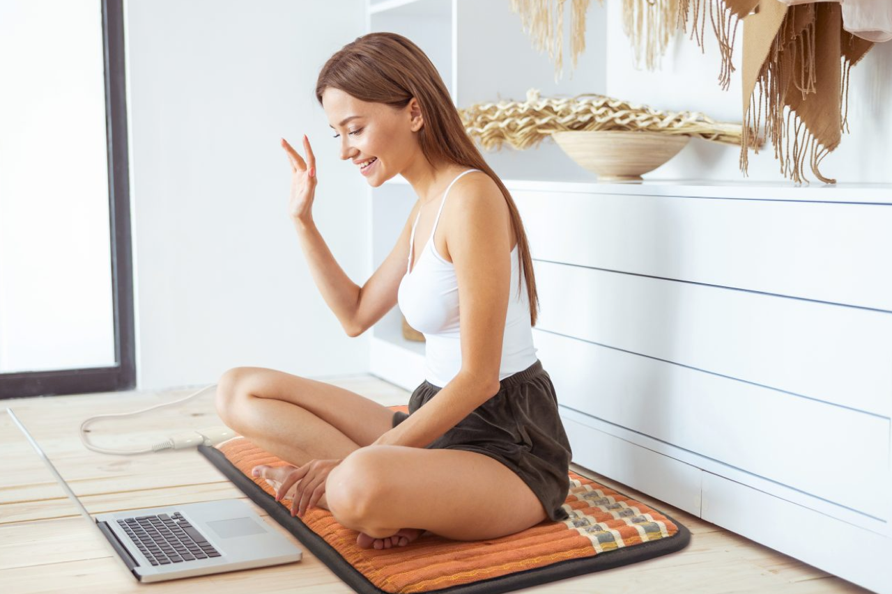 Woman sitting on HealthyLine TAO mat 6024 on the floor